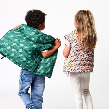 Boy and girl wearing Snapper Rock puffer jackets converted to vest.