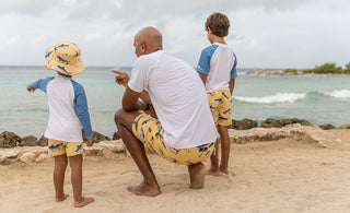 Shark Week Activities for Kids - Dad and boys wearing matching shark print swimsuits.