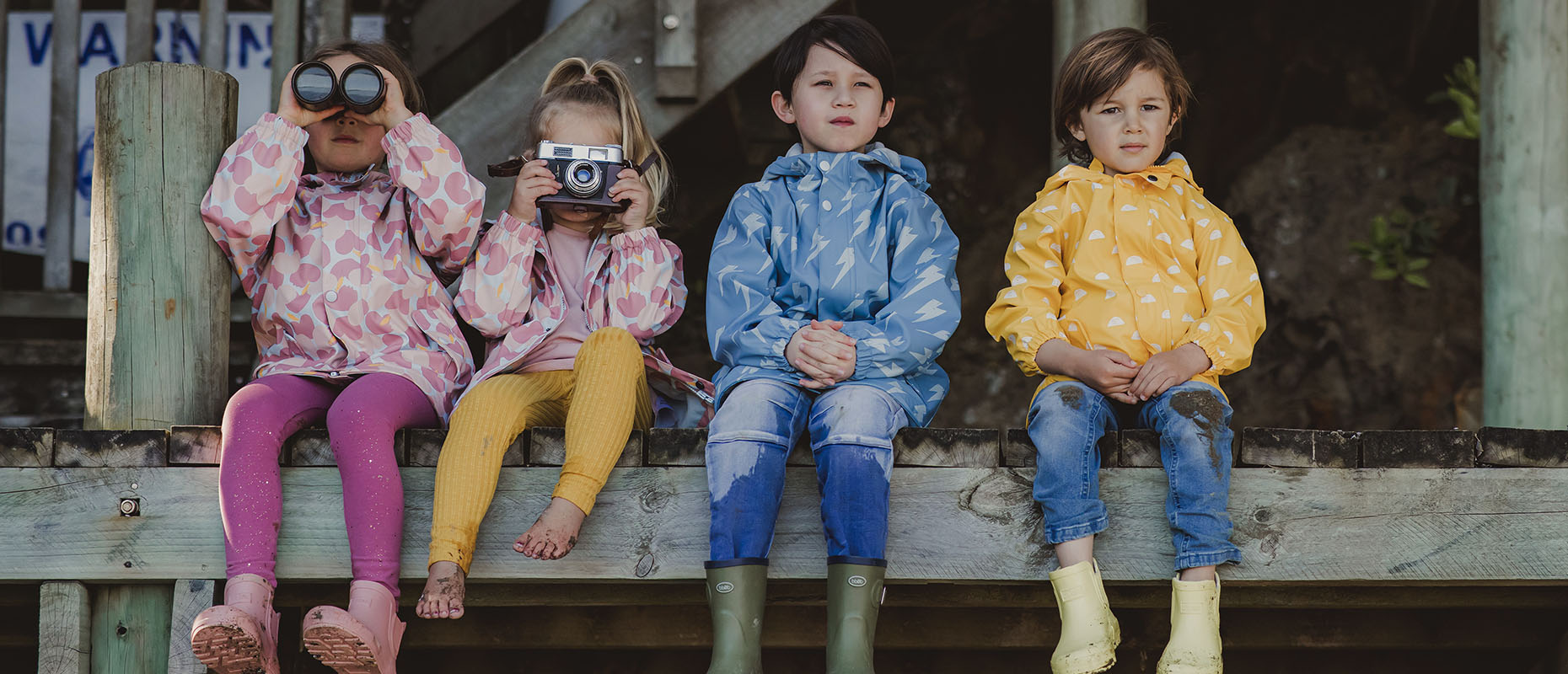 Boys and girls raincoats - pink, blue and yellow designs.