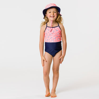 Girl wearing Snapper Rock ditsy coral swimsuit.