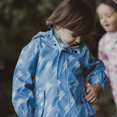 Close up of buttons and pockets on Snapper Rock raincoat.