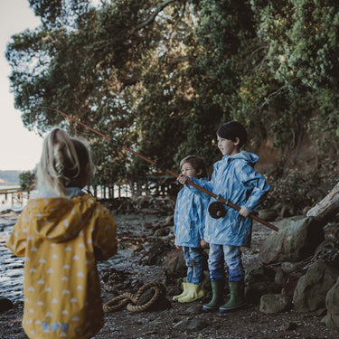 Boys fishing, wearing Snapper Rock waterproof and windproof raincoats.