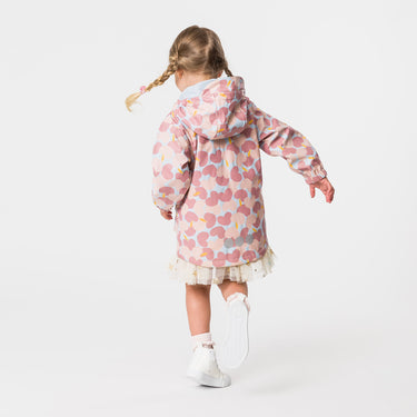 Girl wearing Snapper Rock raincoat spinning around.