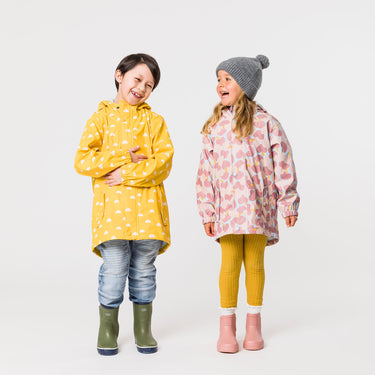 Boy and girl wearing yellow and pink Snapper Rock raincoats.